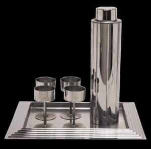 Chrome Manhatttan cocktail set by Norman Bel Geddes with shaker, 4 stemmed glasses, and tray
