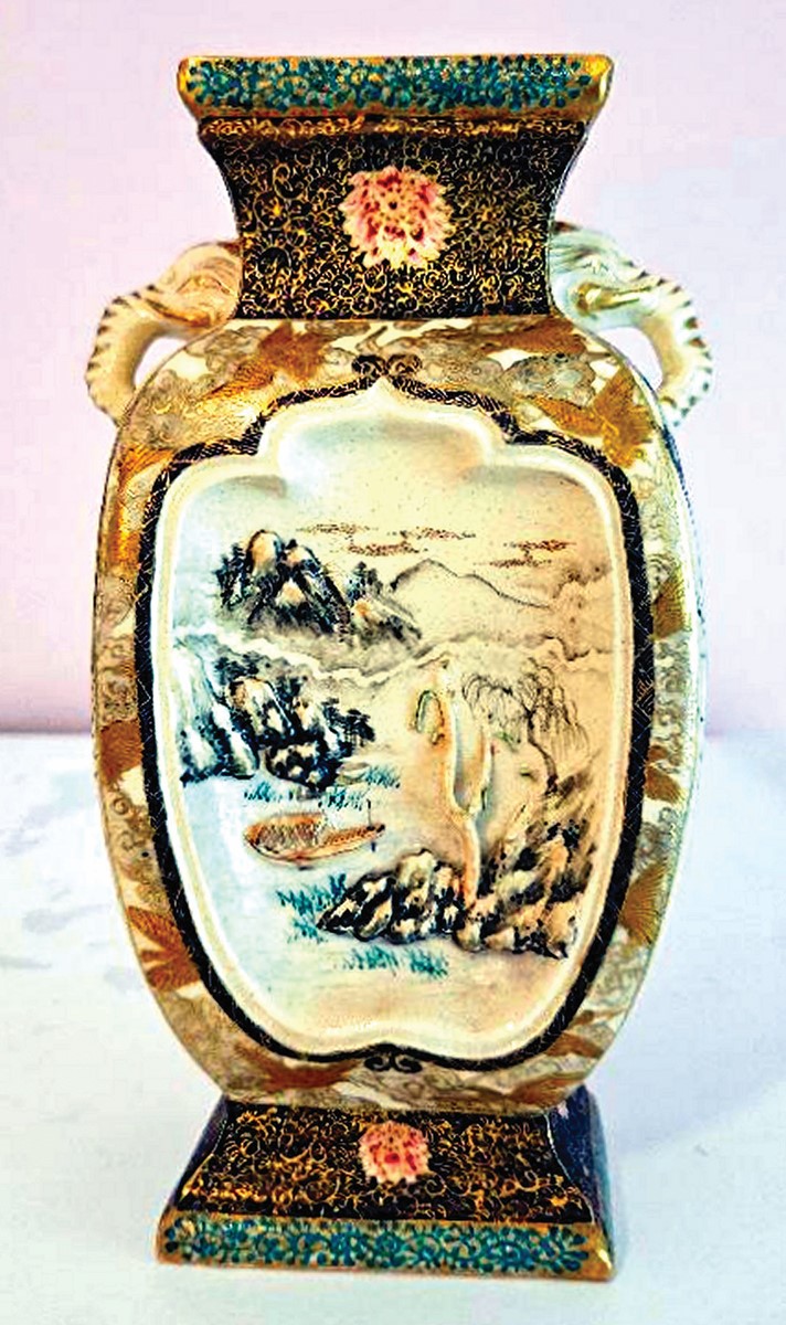 Colorful vase with a scenic panel with a mountain landscape and trees, elephant shaped handles, and square neck and base