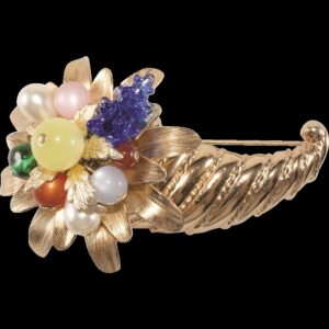 Brooch shaped like a gold tone cornucopia filled with colorful beads and stones