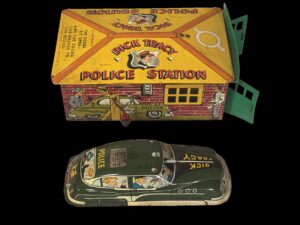 Dick Tracy toy set consisting of a police station with a yellow roof and a green car