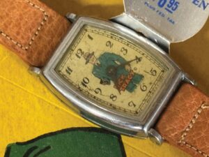 Closeup of rectangular wristwatch face with image of character Dick Tracy