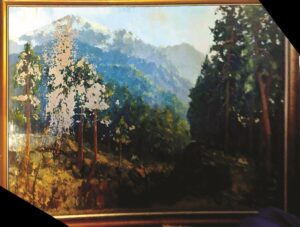 Large rectangular landscape painting with mountains in background and trees in foreground, patches of paint worn away