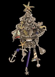 Silver tone Christmas tree pin with nautical themed decorations and hanging charms