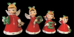 Set of 4 porcelain angels in red robes, lined up largest to smallest, each holds a green letter of "NOEL"